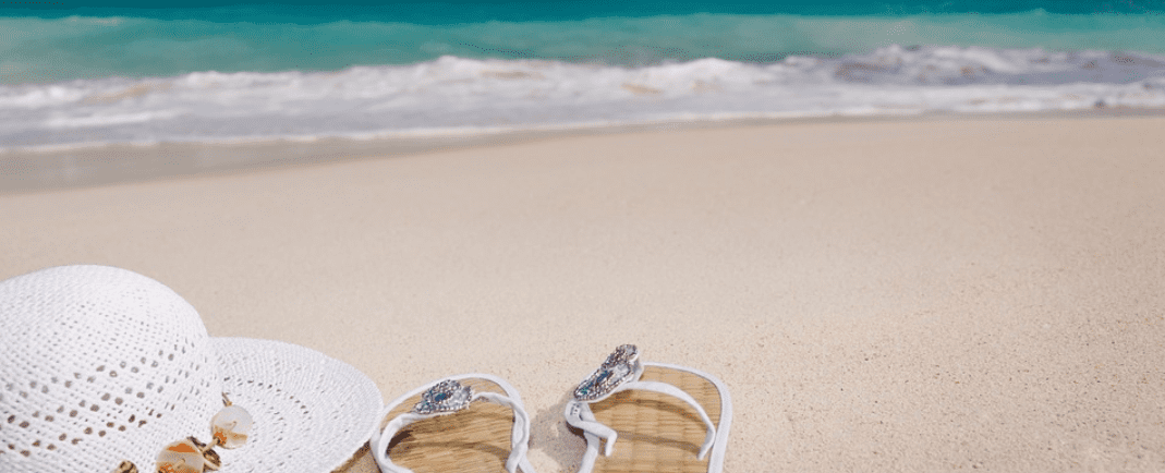 hat and sandals on the beach