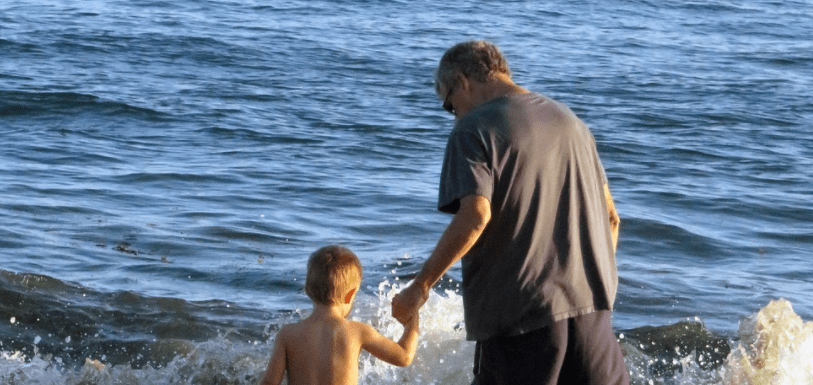 Older father and son at the beach