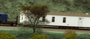 Mobile Home being transported up a hill