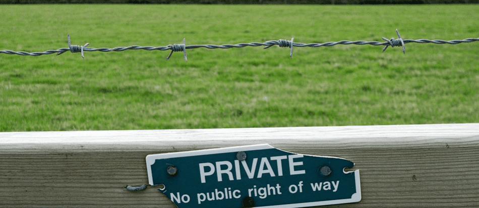Private property sign under barbed wire