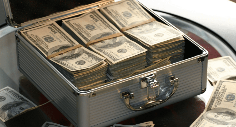 Cash stacked in a small metal briefcase