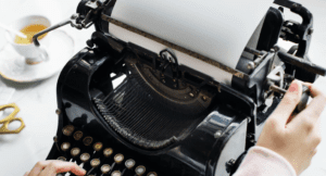 A woman typing using an old typewriter