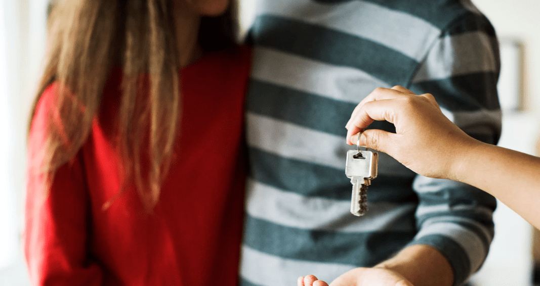 A couple accepting a set of keys to their home