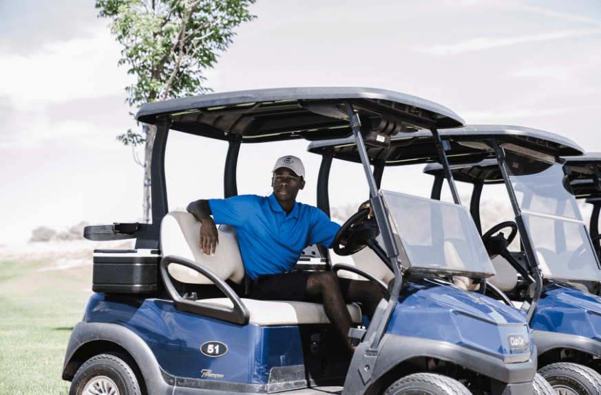 A golf cart driver sitting in the golf cart