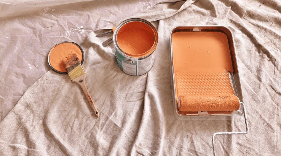 A can and tray of peach colored paint 
