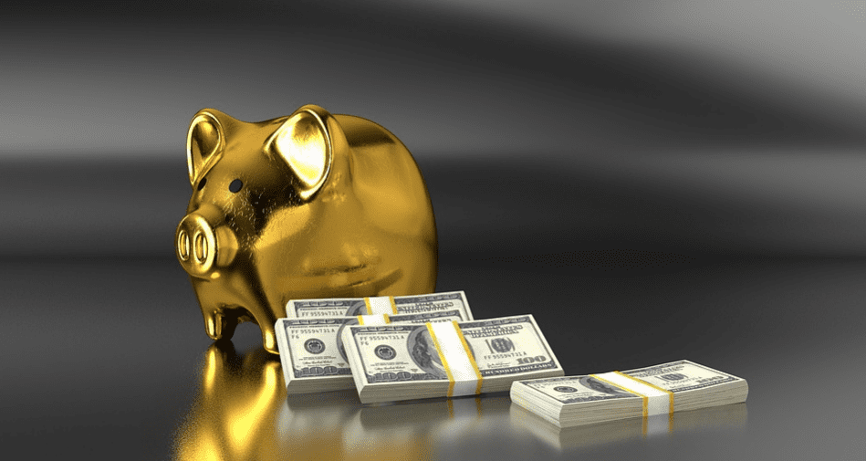 Gold piggy bank with stacks of cash