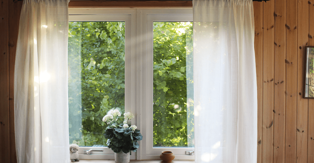An insulated window with clear curtains