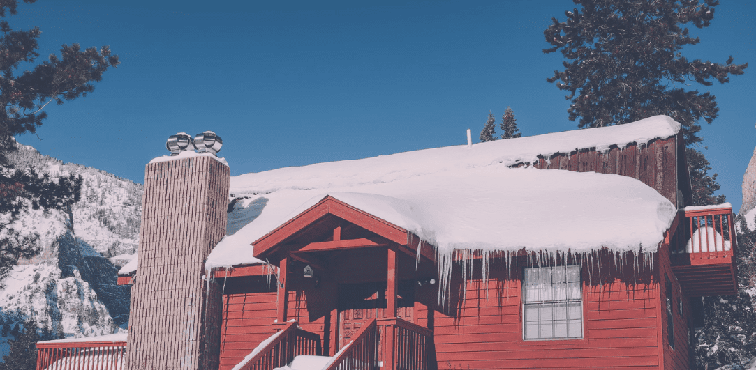 Snow on a red house roof