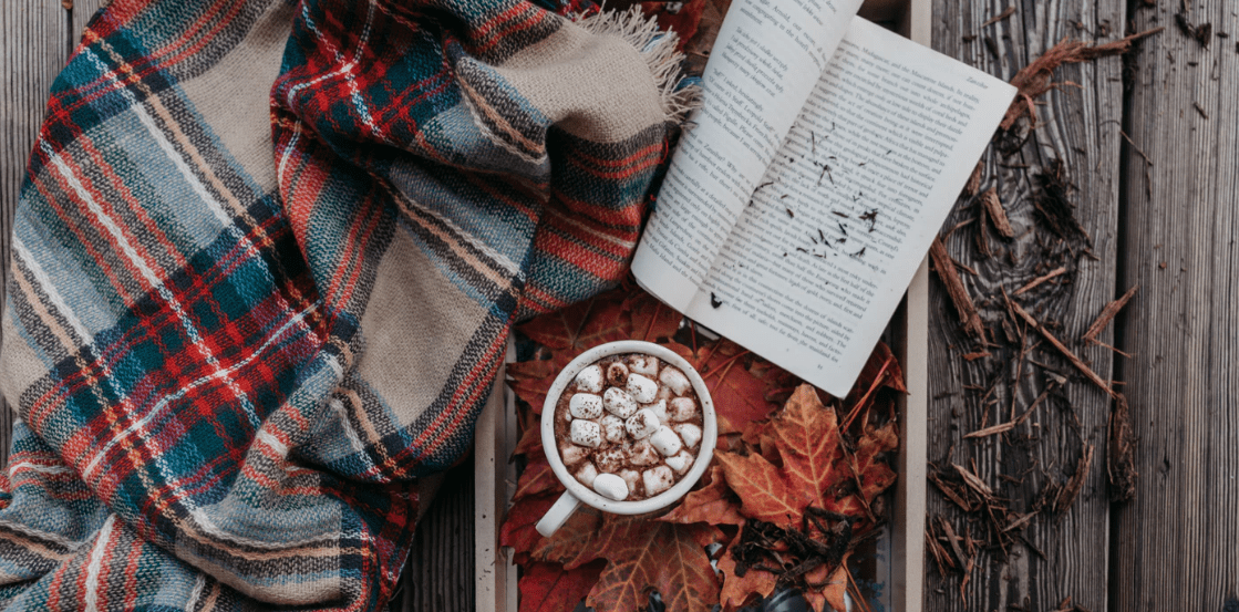 Fall activity with hot cocoa and a book and blanket