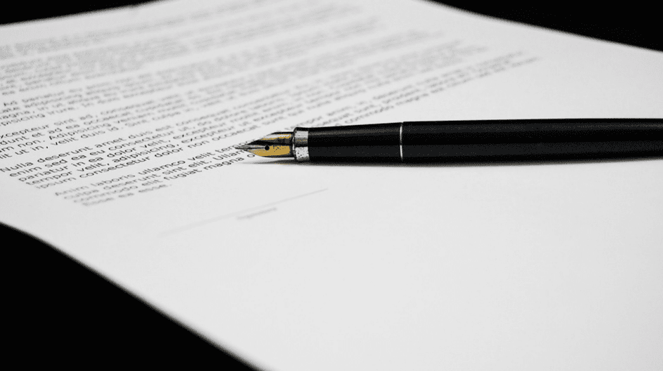 A fountain pen laying on top of a document