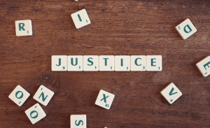 Scrabble tiles spelling out the word JUSTICE