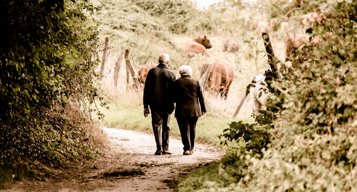 Senior couple walking down a lane