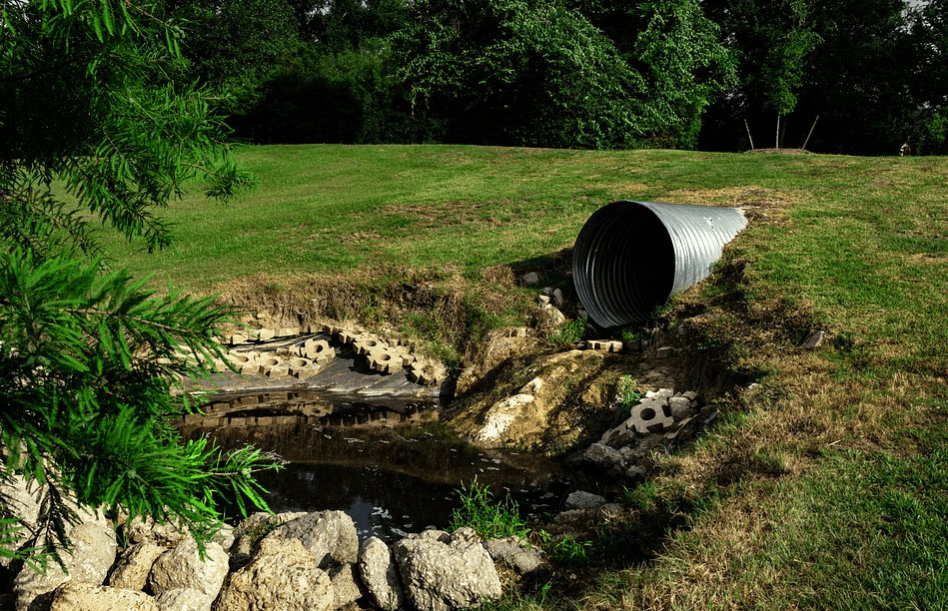 Sewer drain into a puddle