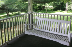 White porch swing on a deck
