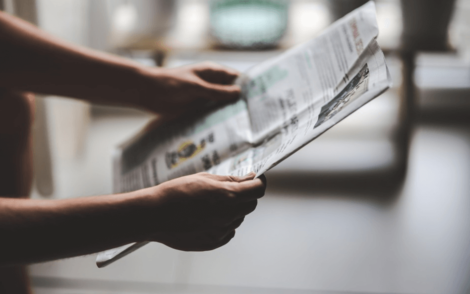 A man holding a newspaper