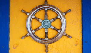 A ship's wheel hanging on the wall