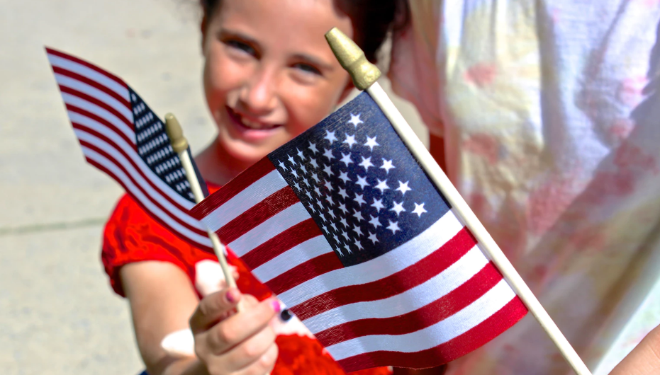 A girl holding an American flag