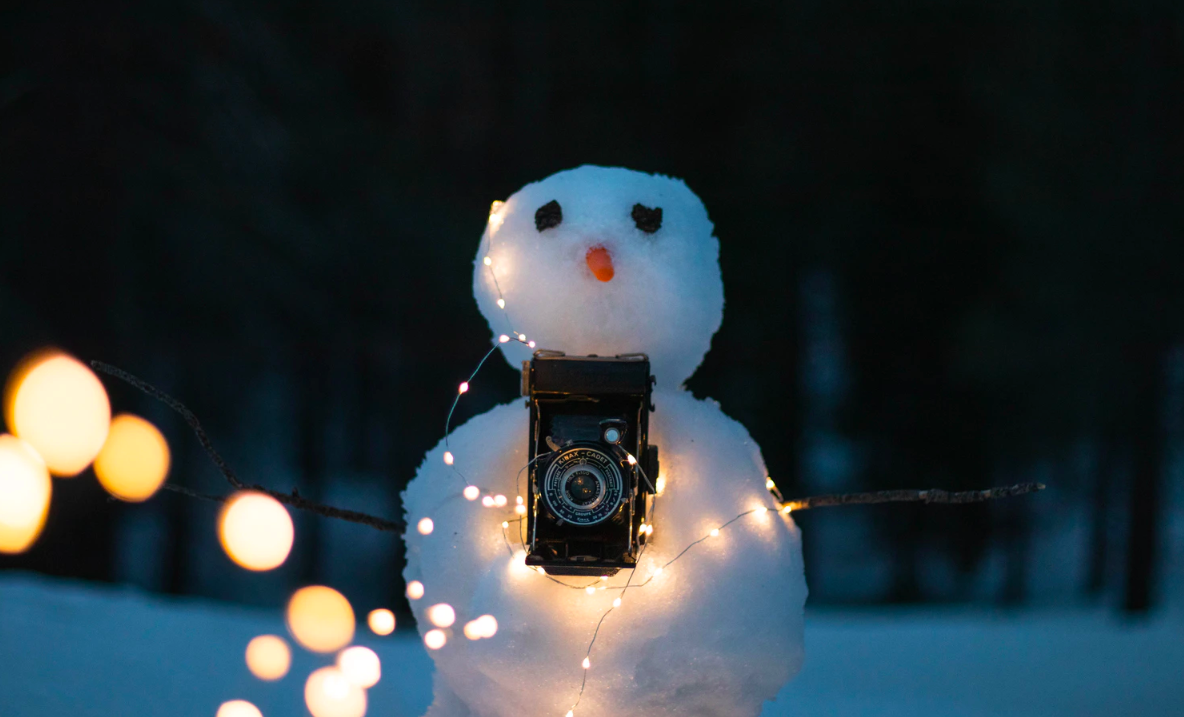 Snowman with lights and camera