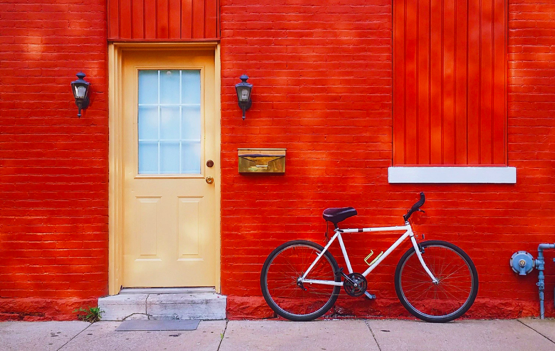 Yellow door of a red painted brick building