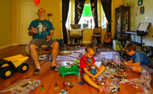 A father and two sons with lots of toys