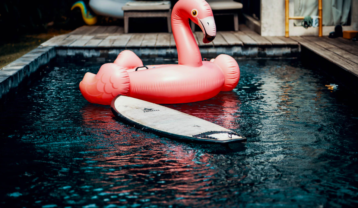 Inflatable flamingo and board in pool