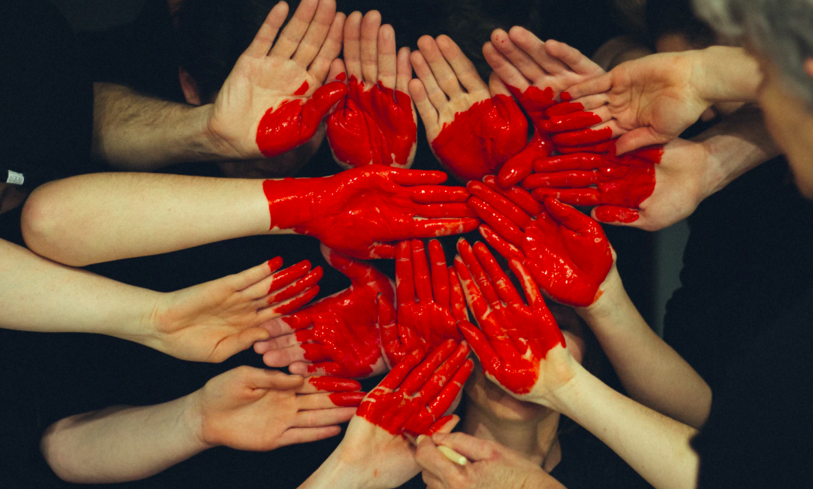 Hands painted together for a red heart